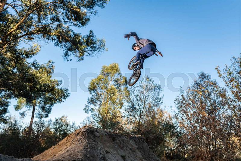 BMX Bike jump over a dirt trail on a dirt track, stock photo
