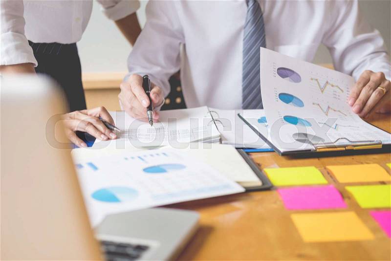 Business team data analyzing income charts document during discussion explain strategy meeting. on start-up project teamwork together, stock photo