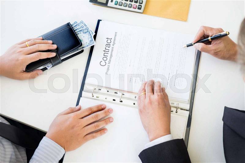 Businessman receive money in the envelope offered in file taking bribe and signing a contract - anti bribery and corruption concepts, stock photo