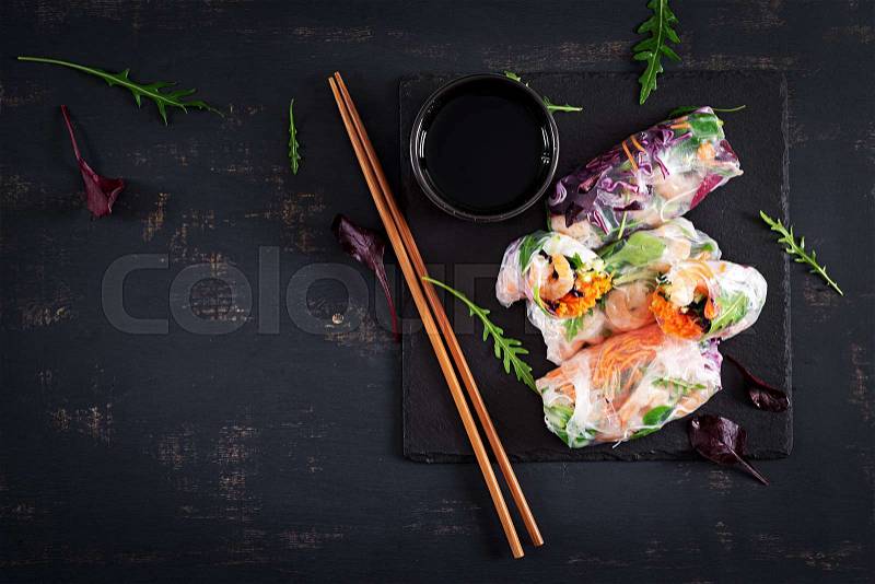 Vegetarian vietnamese spring rolls with spicy shrimps, prawns, carrot, cucumber, red cabbage and rice noodle. Seafood. Tasty meal. Top view, flat lay, copy space, stock photo