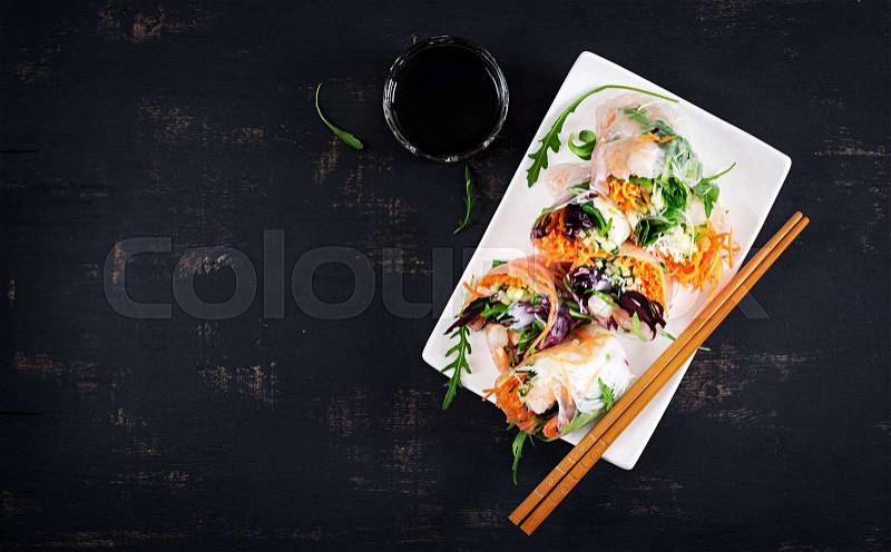 Vegetarian vietnamese spring rolls with spicy shrimps, prawns, carrot, cucumber, red cabbage and rice noodle. Seafood. Tasty meal. Top view, flat lay, copy space, stock photo
