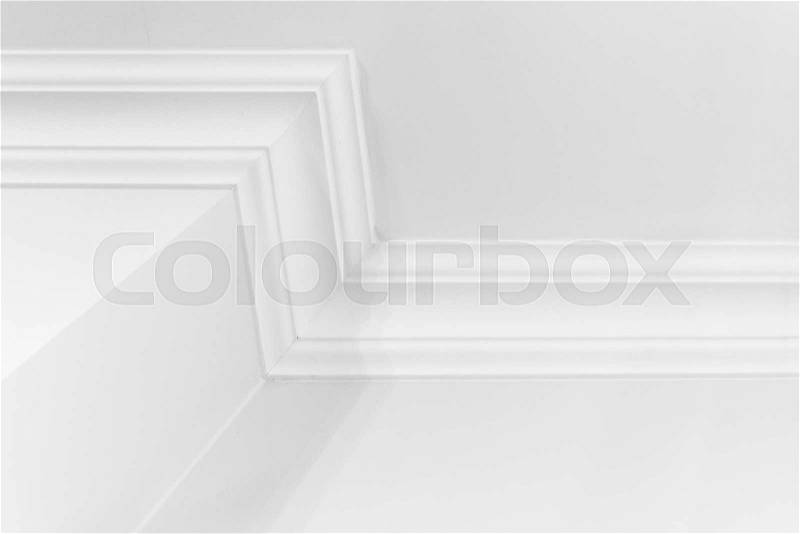 Abstract white interior fragment with walls and decorative ceiling baseboard, stock photo