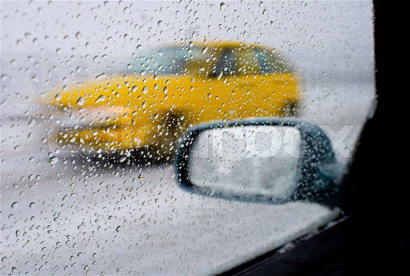 Detail of rear-view mirror in the rainy weather, stock photo