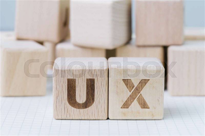 UX development, User Experience design concept, cube wooden block combining acronym UX on gridline notebook, user centric in modern world business, product and ..., stock photo
