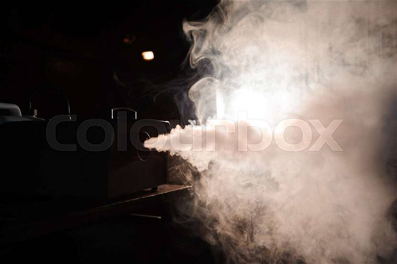 Smoke machine in action, lights in smoke, stock photo