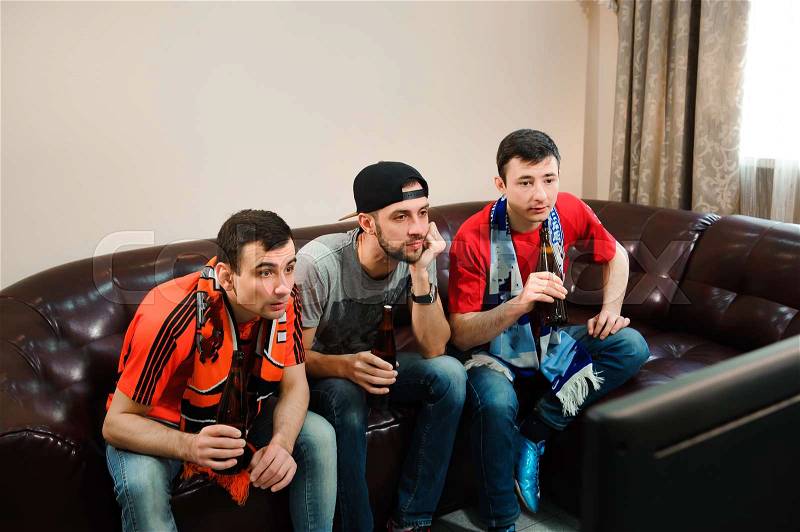 Football friends fans watching football, soccer at home, stock photo