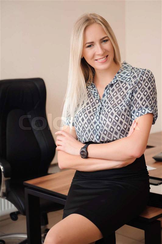 Beautiful happy business woman working with sales in her office, stock photo