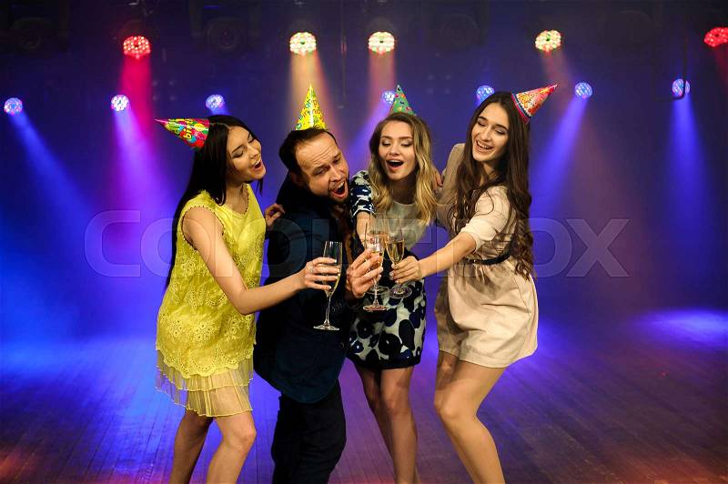 Cheerful young company celebrates birthday in a nightclub, stock photo