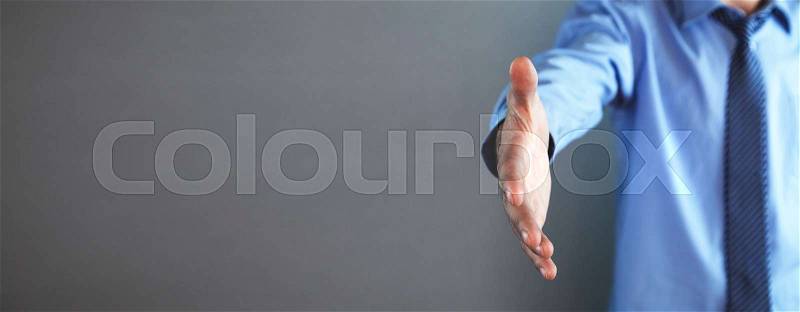 Businessman offering hand for handshake. Deal concept, stock photo