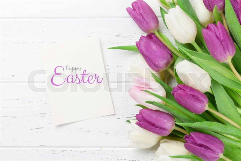 Easter greeting card with tulip flowers bouquet. Over white wooden table with space for your greetings, stock photo