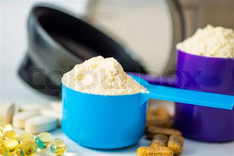 Sport food supplements. Sport Pills, vitamins and protein powder on the white table, stock photo