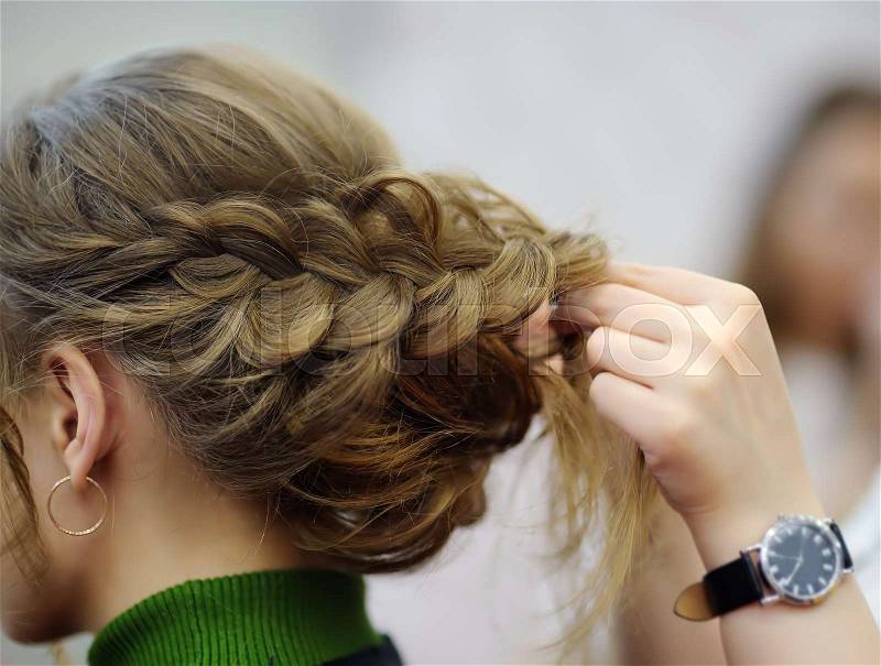 Young woman/bride getting her hair done before wedding or party. Wedding or prom ball hairstyles, stock photo