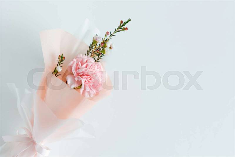 Spring flowers. Fresh bouquet with carnation in minimal style on light background. Top view, spring flat lay with copyspace for text. Love and gift concept, stock photo