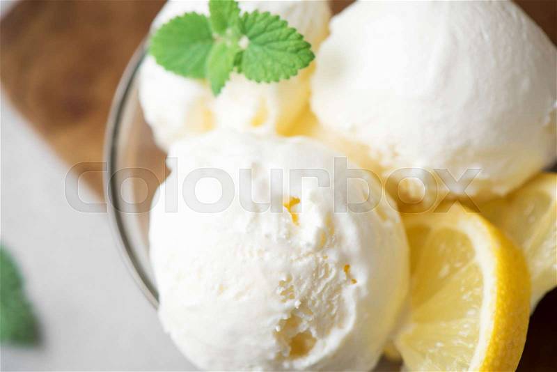 Lemon Ice Cream in bowl. Homemade citrus lemon ice cream with mint close up, stock photo