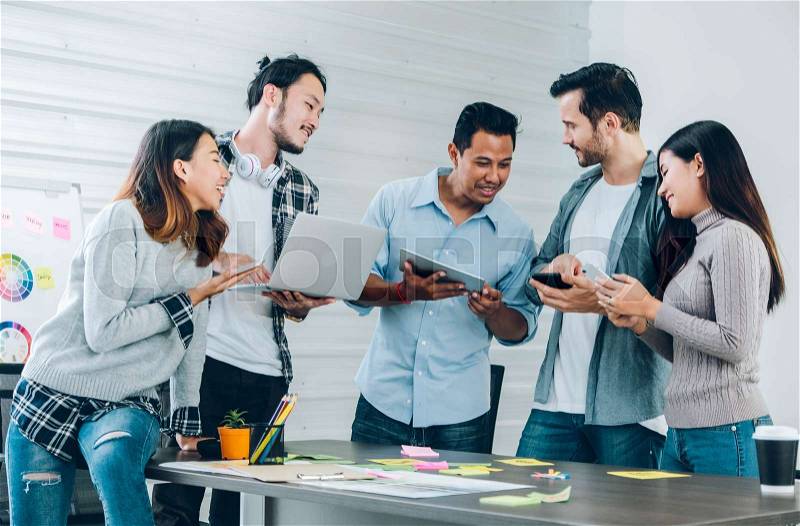 Diversity Designer in casual cloth using technology device at meeting table in meeting room at creative office, stock photo