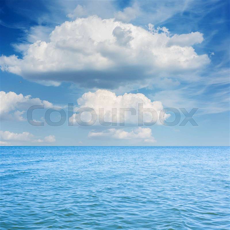 Blue sea and low clouds over it, stock photo