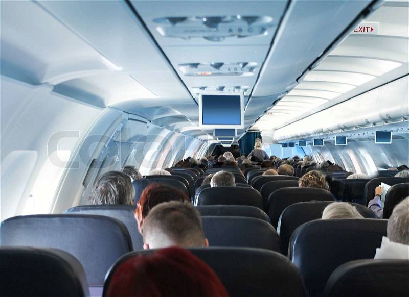 Overhead view of passengers traveling in airplane cabin interior economy class, stock photo