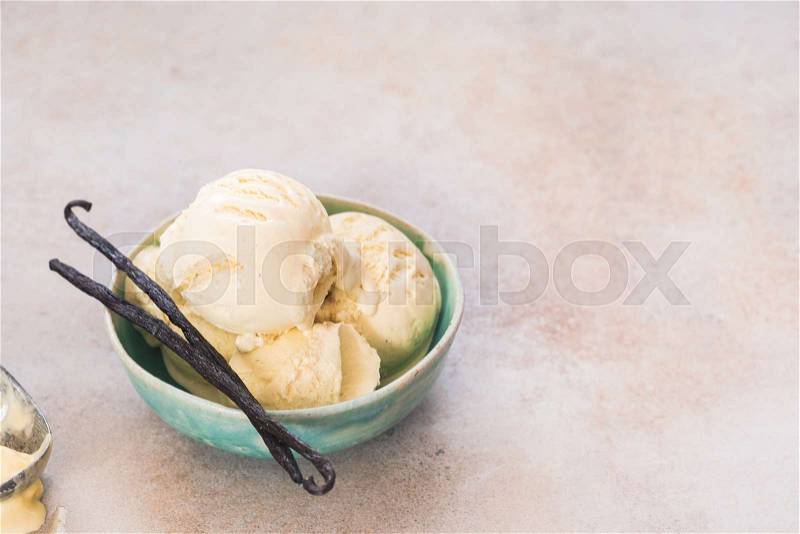 Vanilla Bean Ice Cream. Vanilla ice cream in bowl with vanilla pods, selective focus, copy space, stock photo