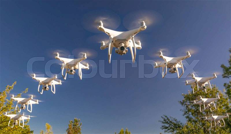 Formation of Drones Swarm in the Blue Sky, stock photo