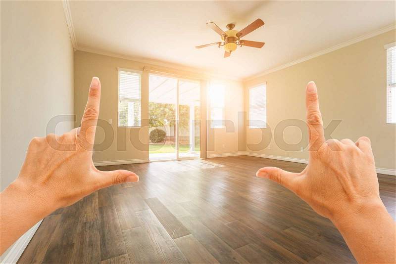 Female Hands Framing Empty Room of House, stock photo