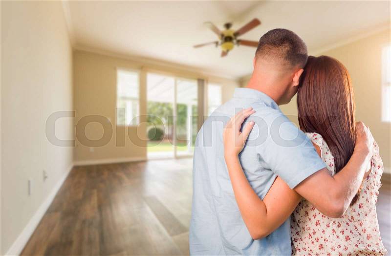 Young Military Couple Looking At Empty Room of New House, stock photo