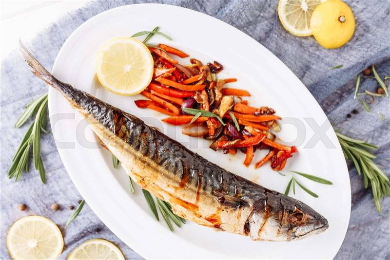 Grill Fried Mackerel Scomber Fish Top Flat Lay. Whole Golden Smoked Cooked Maccarello with Vegetable, Rosemary and Lemon Above View on White Plate. Barbecue Prepared ..., stock photo