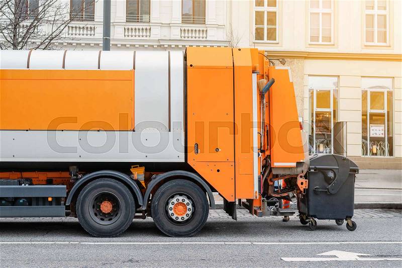 Garbage disposal lorry at city street. Waste dump truck on town road. Municipal and urban services. Waste management, disposal and recycling. Mock-up empty space. ..., stock photo