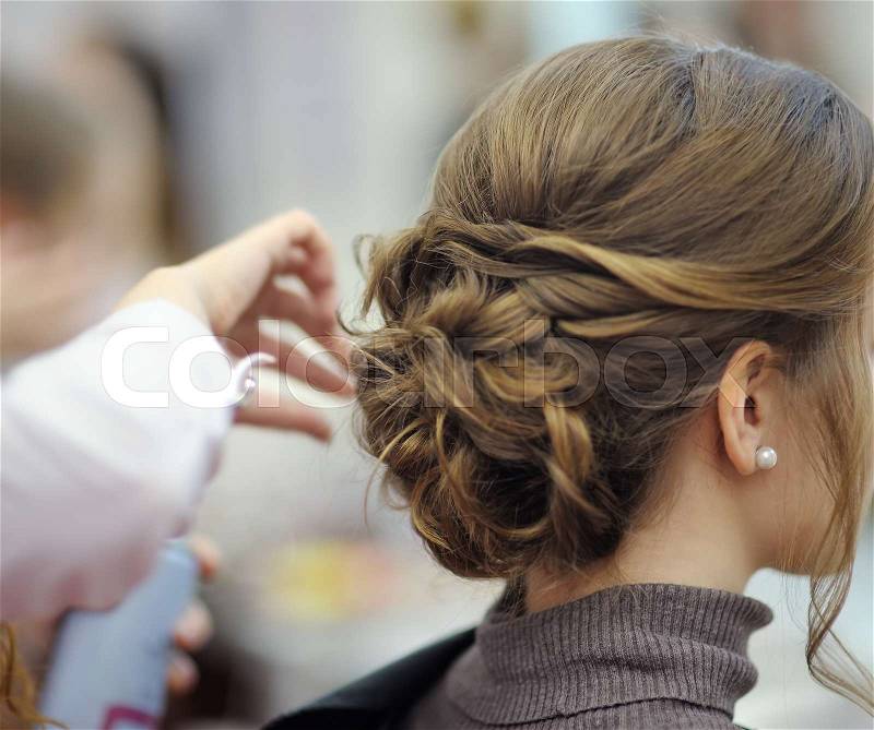 Young woman/bride getting her hair done before wedding or party. Wedding or prom ball hairstyles, stock photo