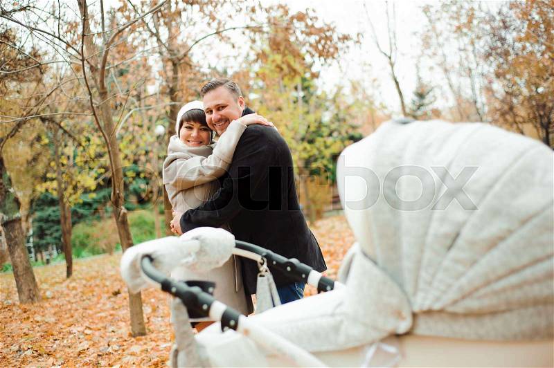 Mom and Dad hugging in the autumn park, stock photo