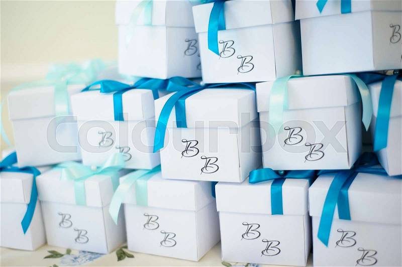 Wedding ceremony decoration, boxes for sweents with blue bow, stock photo