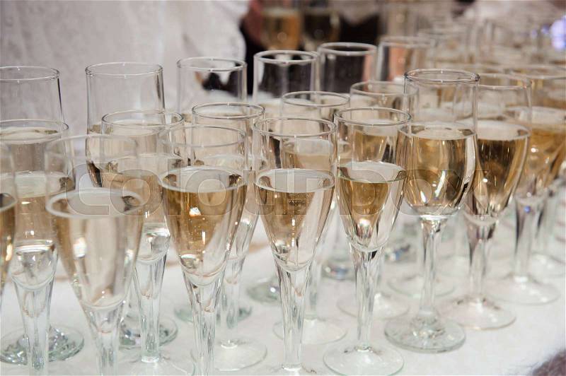 Waiter pours champagne in glasses, luxury event, stock photo