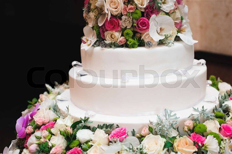 Wedding details - wedding cake dessert with flowers as decor, stock photo