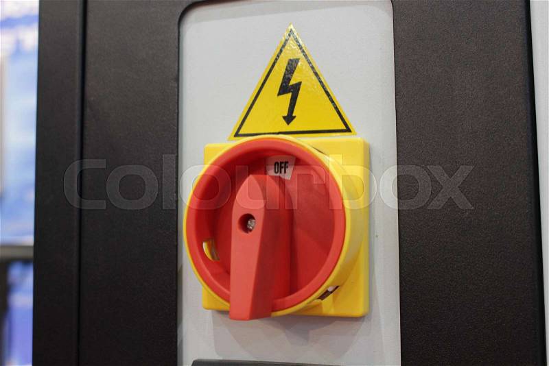 Red high voltage on off switch for industrial machine, stock photo