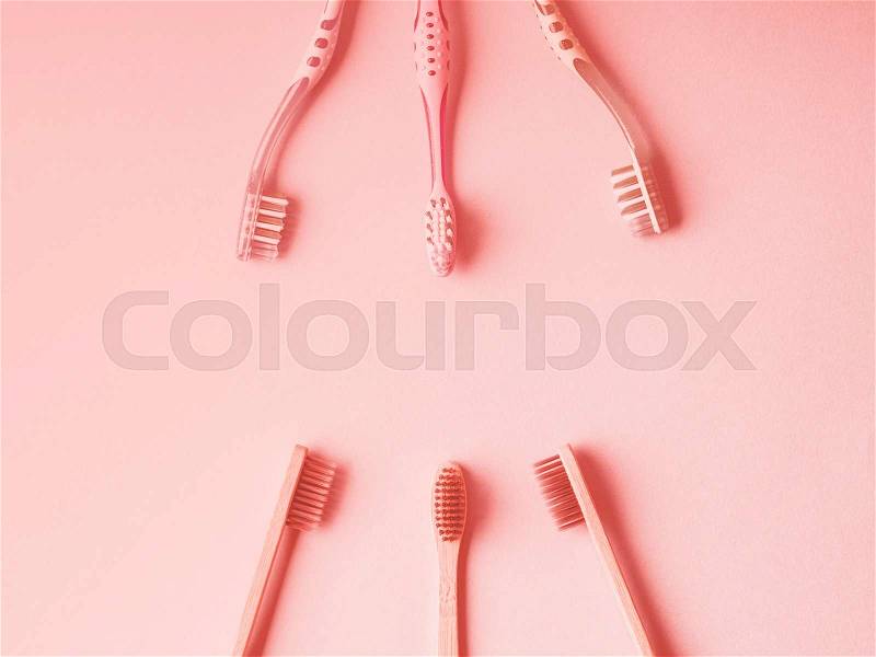 Plastic toothbrushes versus bamboo. Zero waste concept. Living coral tone, stock photo
