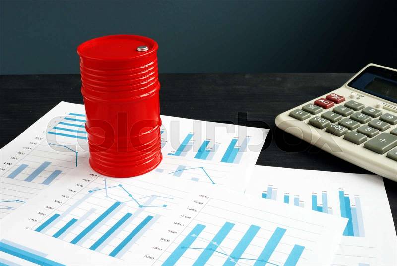 Oil trading concept. Barrel and exchange data with financial reports, stock photo