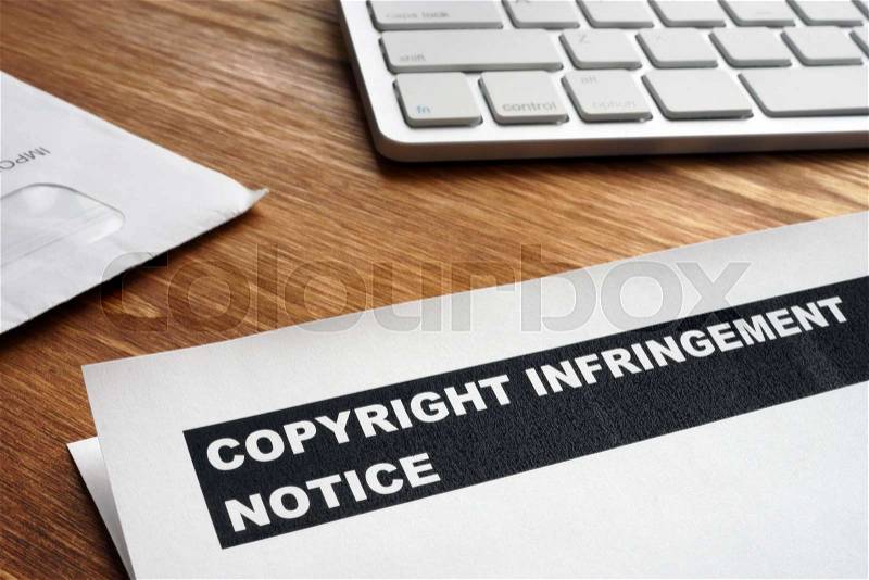 Letter with copyright infringement notice on a desk, stock photo