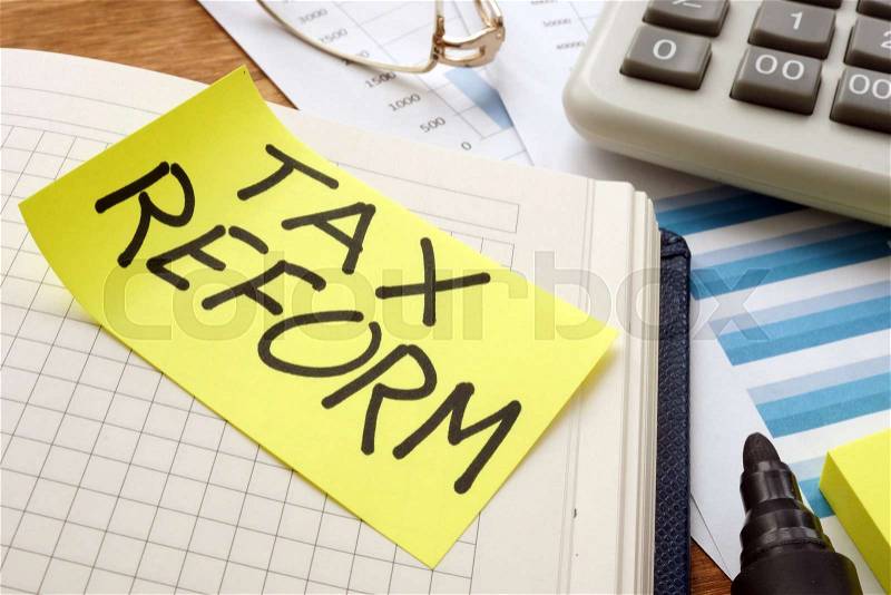 Tax reform. Business papers, note and calculator, stock photo