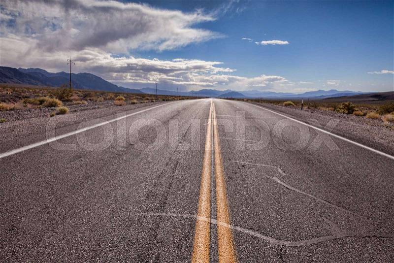 Road through desert area near Death Valley, California, stock photo