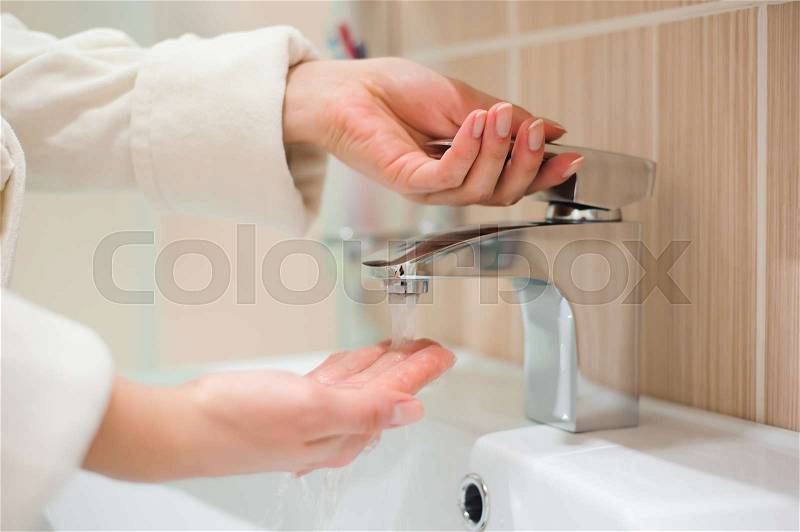 Washing of hands with soap under running water, stock photo