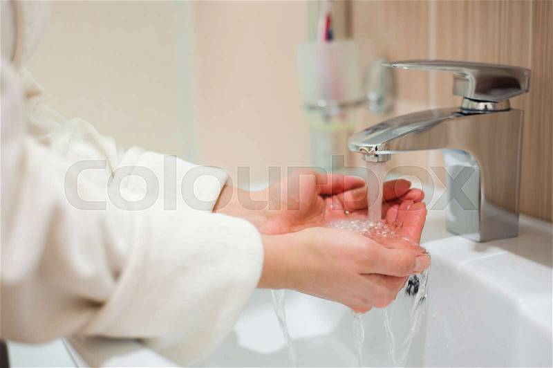 Washing of hands with soap under running water, stock photo
