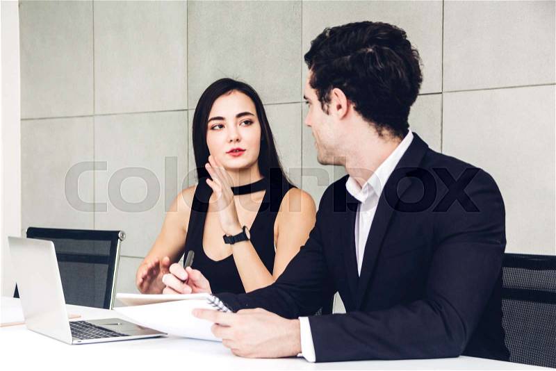 Two business people working and discussing strategy with laptop computer.creative business people planning and brainstorm in modern work loft.Teamwork concept, stock photo