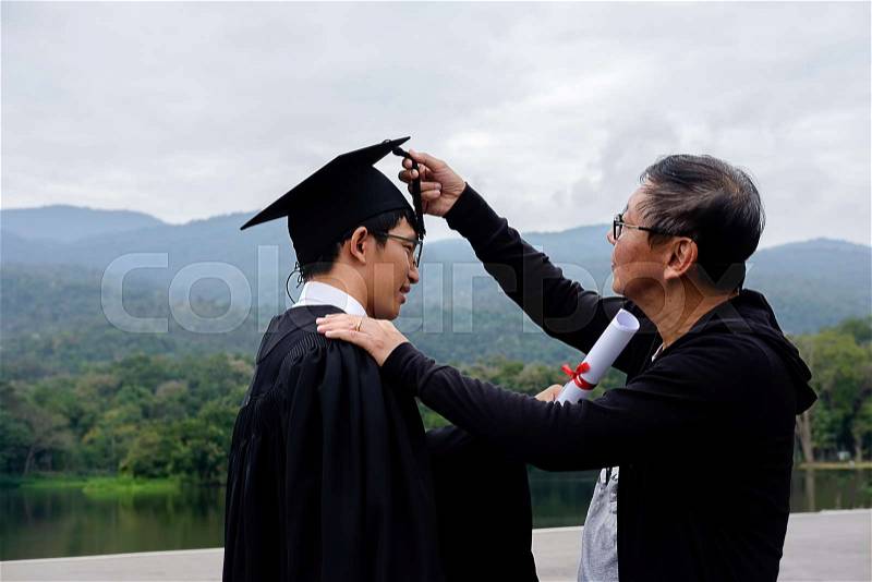 Happy man on her graduation day University. student in graduation cap with certificate. Education and people, stock photo