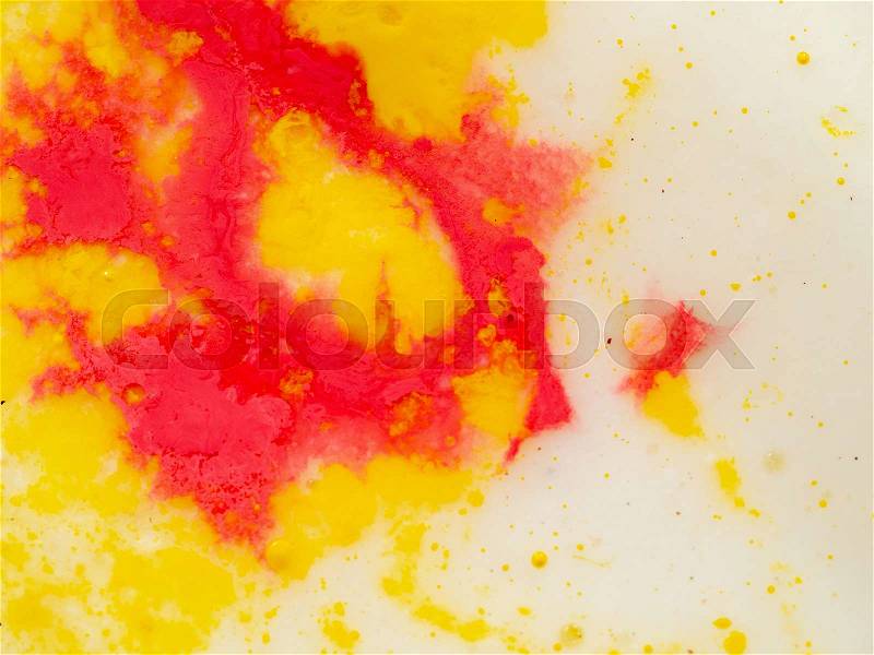 Yellow red pattern on bright background. Close up shot. Abstract background. Colourful abstract pattern of yellow and red paint. Paint splashes. Macro shot. Blurred ..., stock photo