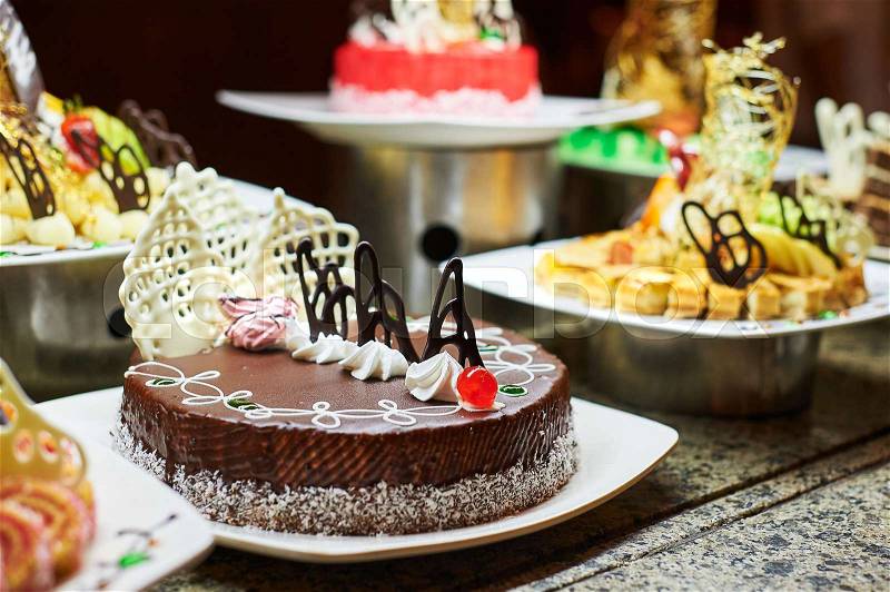 Sweets on banquet table - picture taken during catering event. Rows of tasty looking desserts in beautiful arrangements, stock photo
