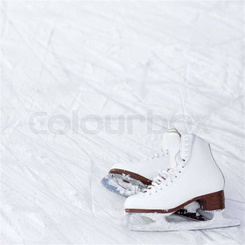 Figure skates and copy space over ice background with marks from skating, stock photo
