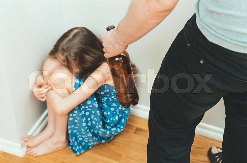 Drunk father in front of frightened little girl. Domestic violence concept, stock photo