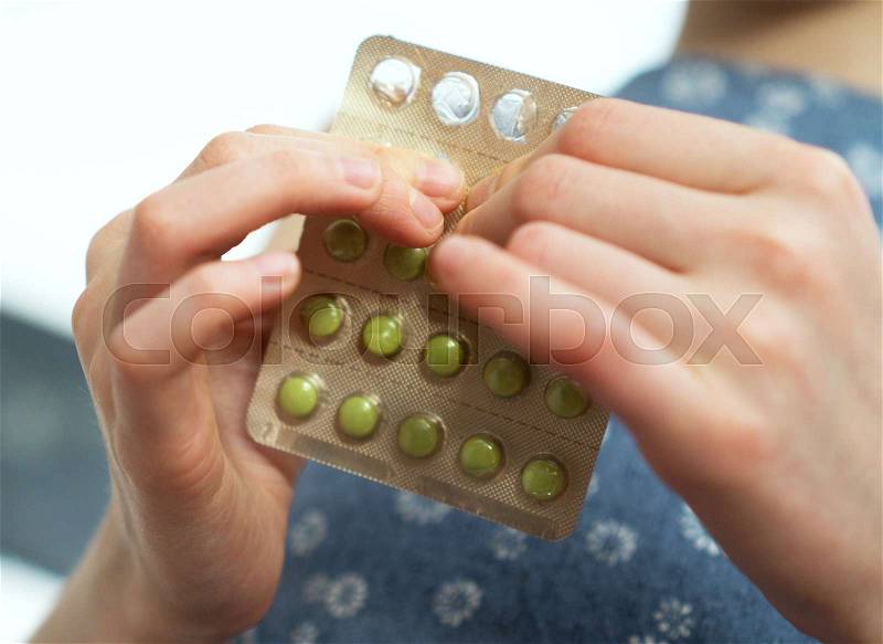 Child takes pack of pills. Dangerous situation, stock photo