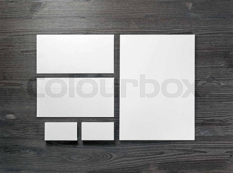 Blank corporate stationery on wood table background. Flat lay. Responsive design mock up, stock photo