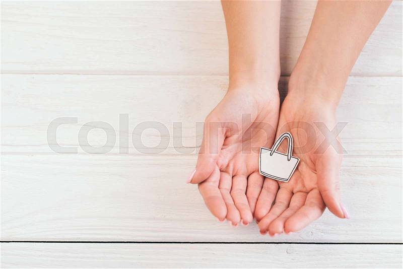 Top view of woman holding paper bag in hands, stock photo