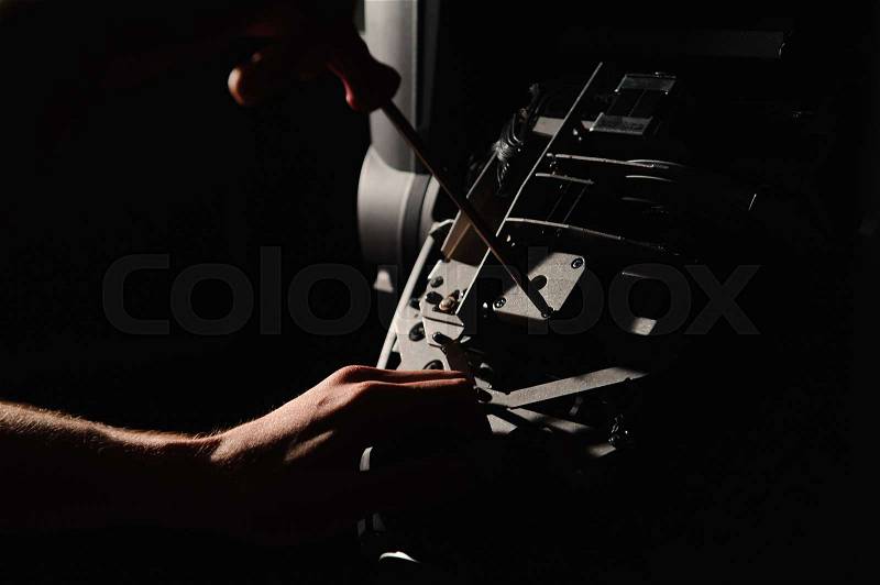 The lighting engineer repairs the light device on stage, stock photo